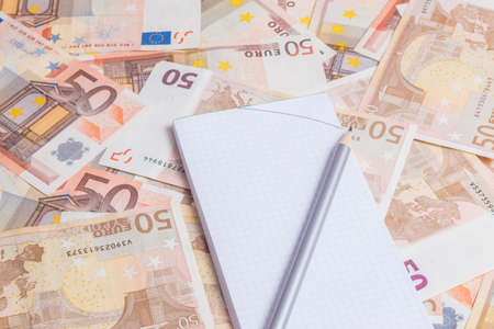 Financial concept. Office supplies over fifty euro notes backgroundの写真素材