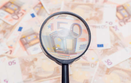 Closeup of fifty euro notes through magnifer backgroundの写真素材