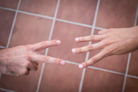 Two hands playing odds and evens with vintage styleの写真素材