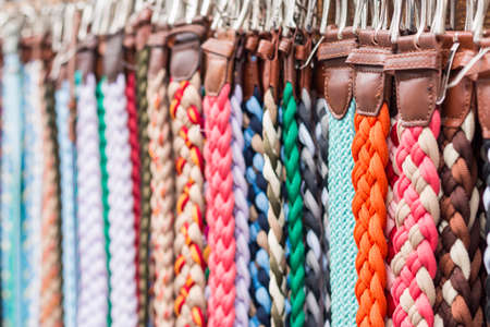 Background colorful variety of straps hanging from the wallの写真素材