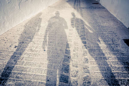 Three people shadows on the street with vintage lookの写真素材