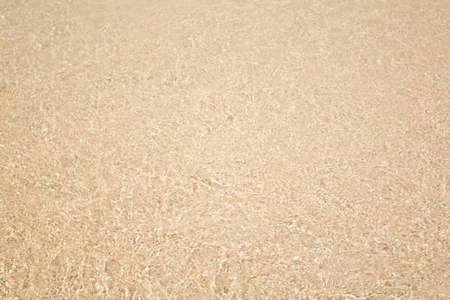 Golden brown sand of beach texture backgroundの写真素材