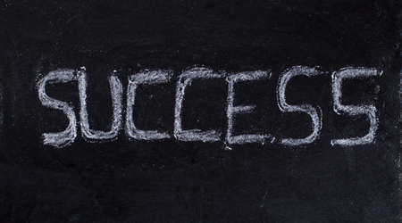 Success written on black chalkboard bacgroundの写真素材