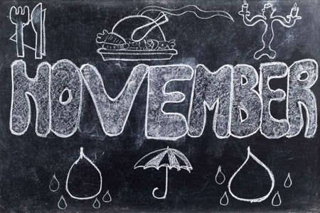 Handwritten November  with Thanksgiving and raining symbols on black chalkboardの写真素材