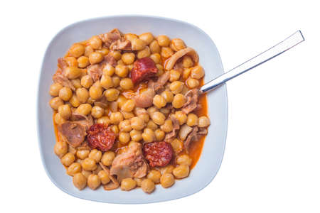 View of ceramic plate full of chickpeas and meat served with spoonの写真素材