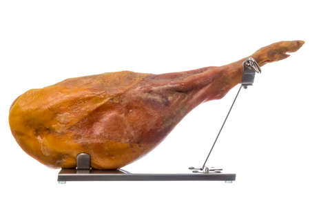 Studio shot of roasted pork ham served on special stand isolated on white backgroundの写真素材