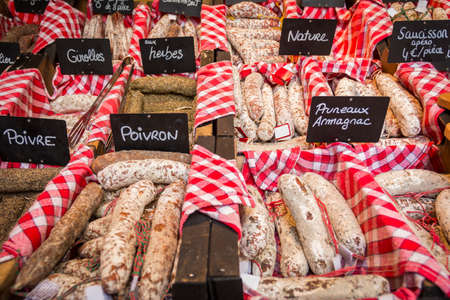 Different tasty sausages placed on counter in the shopの写真素材