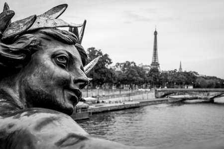 View to Seine river and big metallic man statue decorated on Pont Alexandre III in Parisの写真素材