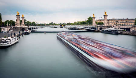 Big blurred ship sailing in Seine river in Paris in long exposureのeditorial素材