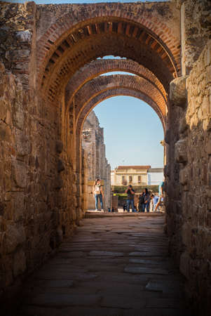 Merida, Spain - Oct 28, 2017: group of unrecognizable tourists taking shots in a corridor of...