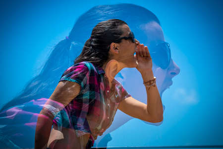 Side view of young female in casual outfit keeping hand near mouth and shouting while on background...