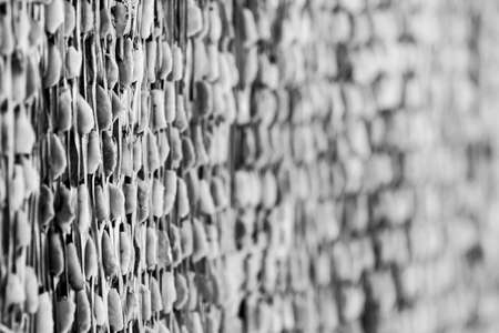 Textured background of nice wall composed of perforated lumber panelsの写真素材