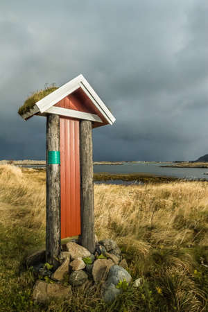 Old sign which stands on the sea shoreの写真素材