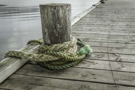 Rope for mooring on an old wooden pierの写真素材