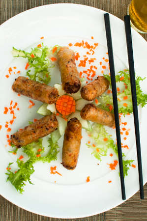 Six spring rolls for lunch with chopsticks top viewの写真素材