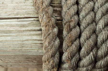 Old wooden texture with time-worn pirate rope backgroundの写真素材