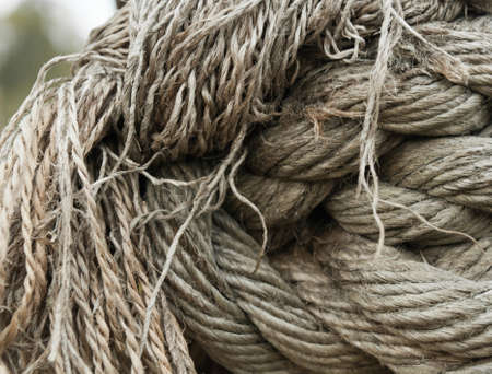 Knots and fibers of old pirate ship rope closeup viewの写真素材