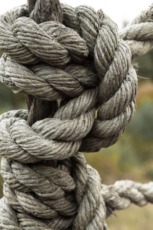 Strong knot of time-worn ship rope closeupの写真素材
