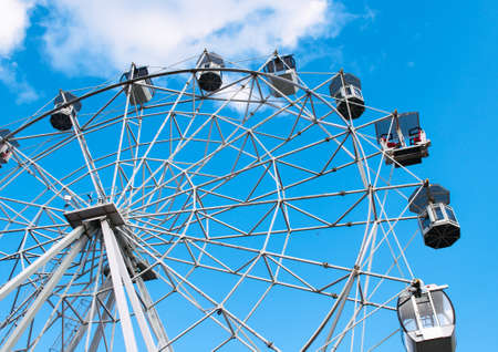 Attraction Ferris wheel on the bright blue sky backgroundの写真素材