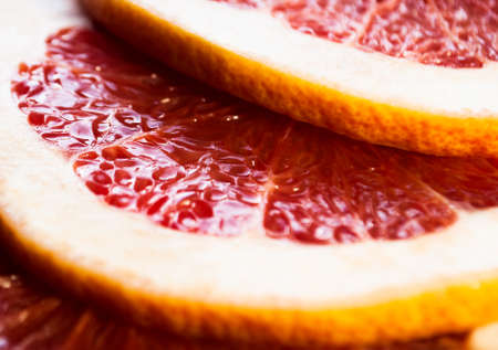 Slices of grapefruit or red orange closeup macro viewの写真素材
