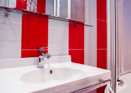 Splashy bathroom interior in red and white colors in modern styleの写真素材