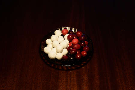 cranberries in icing sugar and red on a dark surface
