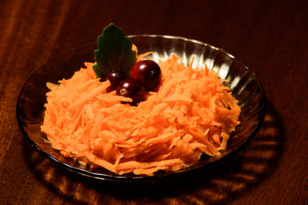 delicious carrot salad with cranberries on a dark surfaceの写真素材