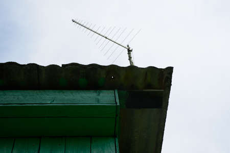 a beautiful corner of the hut on a nice day with a roof antenna
