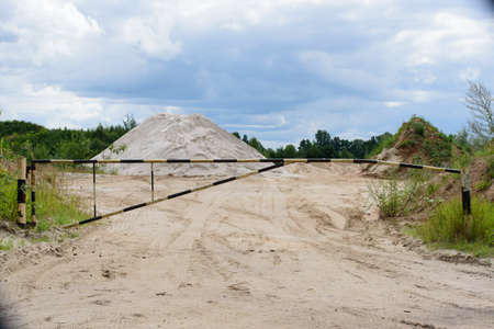 beautiful white sand on the edge of a quarry with a limited area on a cloudy day in midsummerの写真素材