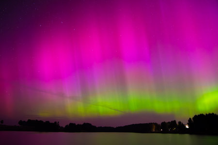 beautiful northern lights in the lake on a clear autumn nightの写真素材
