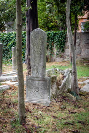 ISTANBUL, TURKEY - September 30, 2015: Gravestones in the old  abandoned cemetery in Kadikoy in Istanbul, Turkey.のeditorial素材