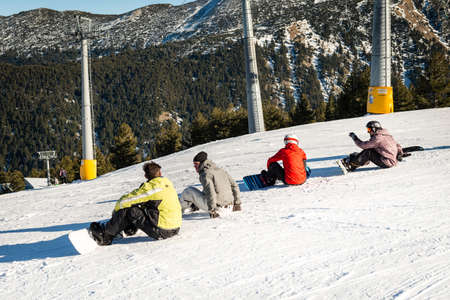 Bansko, Bulgaria - December 29, 2015: Snowboarders resting in ski resort's station up in the mountains.のeditorial素材