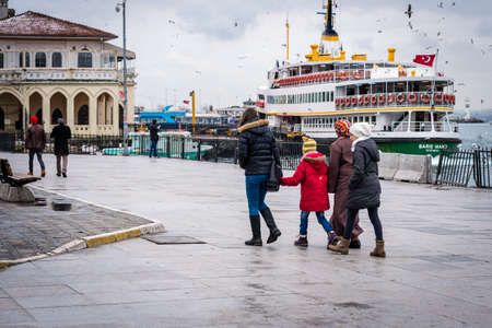 Istanbul, Turkey - January 18, 2016: People are walking near the ferry port in Kadikoy, on the background of ferry pier.のeditorial素材