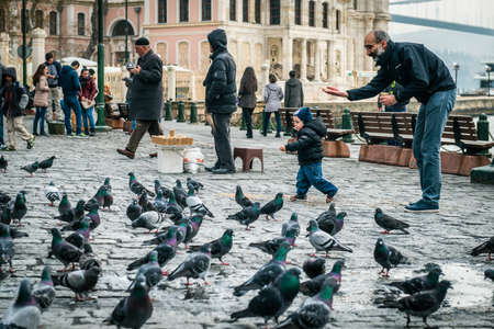Istanbul, Turkey - January 31, 2016: People spending time on weekend and children are feeding pigeons near Bosphorus in Istanbul.のeditorial素材
