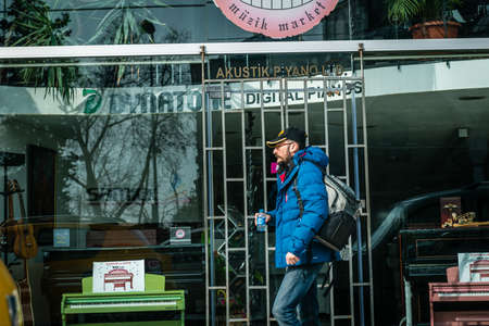 Istanbul, Turkey - January 31, 2016: Man is passing by music shop in Istanbul, Turkey