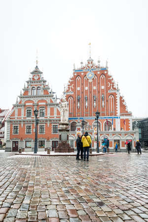 Riga, Latvia - February 20, 2016: People are walking in the center of Riga near the Blackheads House in a snowy winter weatherのeditorial素材