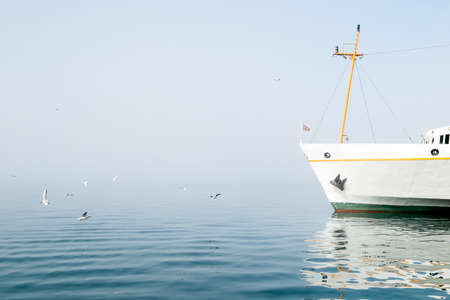 Ferry boat in the water in a fogの写真素材