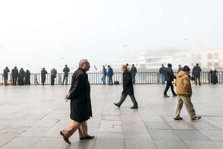 Istanbul, Turkey - February 29, 2016: People are spending time on the coast of Kadikoy. Kadikoy is covered in a smogのeditorial素材