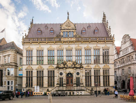 Bremen, Germany - May 28, 2015: People are walking on the streets near the guildhouse of merchants...