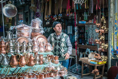 Istanbul, Turkey - March 10, 2015: Turkish man is smoking and selling copper dishes in Istanbul, Turkeyのeditorial素材