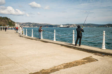 Istanbul, Turkey - March 27, 2016: Men are fishing on the coast of Bosphorus in Tarabya, Istanbul, Turkeyのeditorial素材