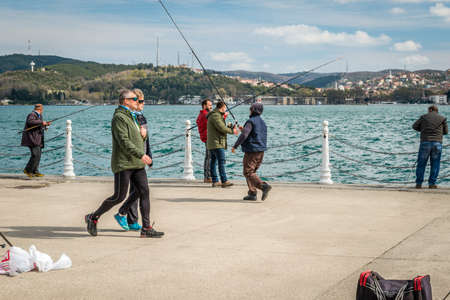 Istanbul, Turkey - March 27, 2016: Men are fishing on the coast of Bosphorus in Tarabya, Istanbul, Turkeyのeditorial素材