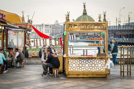 Istanbul, Turkey - April 08, 2016: People are selling and eating fast food on the coast of Eminonu near the Galata bridge in Istanbul, Turkeyのeditorial素材