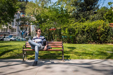 Istanbul, Turkey - April 17, 2016: Turkish man is sitting on bench and having his coffee in the Bebek park in Istanbul, Turkeyのeditorial素材