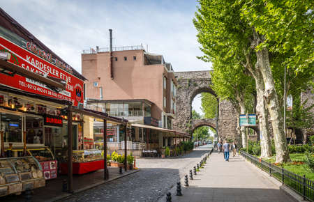 Istanbul, Turkey - April 20, 2016: People are walking near old aqueduct in Zeyrek, Istanbul, Turkeyのeditorial素材