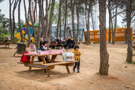 Istanbul, Turkey - April 23, 2016: Mother and son having lunch in the park on the top of the Camlica hill in Istanbul, Turkeyのeditorial素材