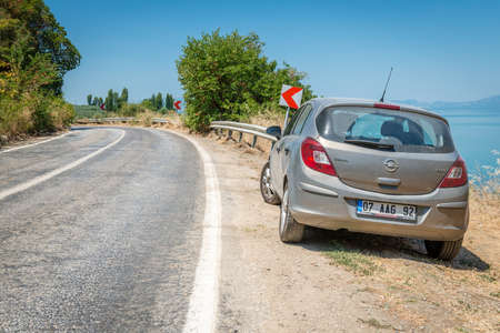 Iznik, Turkey - July 24, 2016: Car parked on Gemlik Iznik Road around the lale of Iznik in Turkeyのeditorial素材