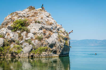 Iznik, Turkey - July 24, 2016: People are jumping from cliff into the lake of Iznik in Turkeyのeditorial素材