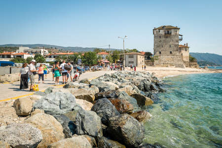 Ouranoupoli, Greece - September 13, 2016: People are gathering near Ancient Ouranoupolis Tower on Athos peninsula in Halkidiki, Greeceのeditorial素材