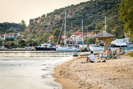 Porto Koufo, Chalkidiki, Greece - September 12, 2016: People are meeting sunset on the beach near the Porto Koufo in Greeceのeditorial素材